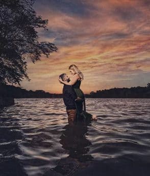 Engagement photogrpahy with couple hugging the water at Lake of the Ozarks