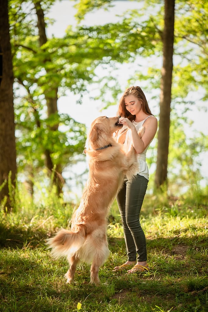 A girl and her dog during a senior photo session at the Lake of the Ozarks